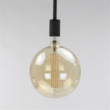 Lyskilde LED-glødetrådssfære Ø20 DH Interiør Ravfarvet glas LxBxH 32x23x23 Ravfarvet glas Atmosfærisk foto diagonalt set forfra